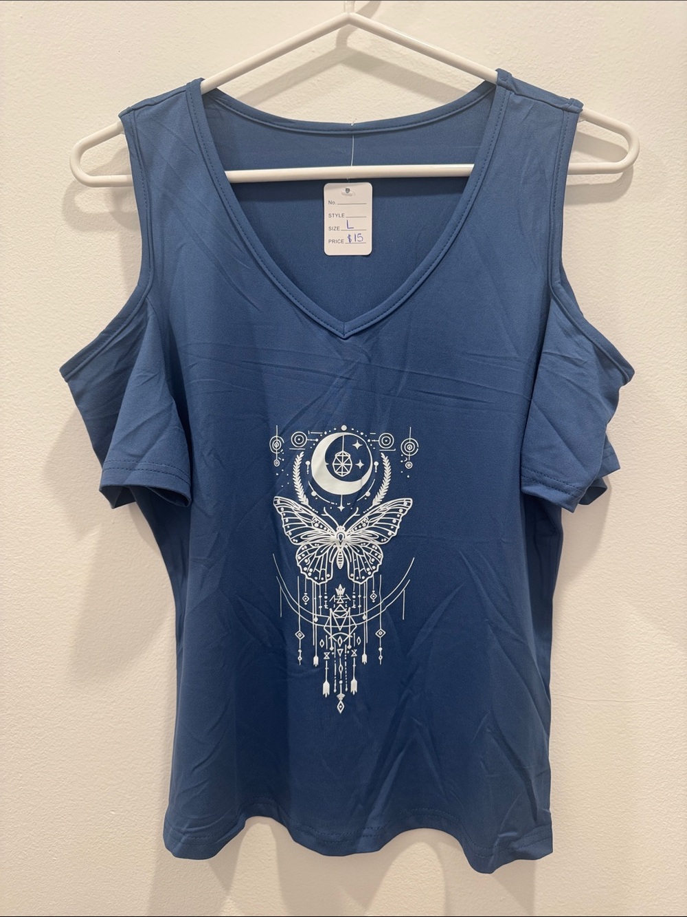 Blue short- sleeve cold shoulder v neck shirt featuring a white graphic print